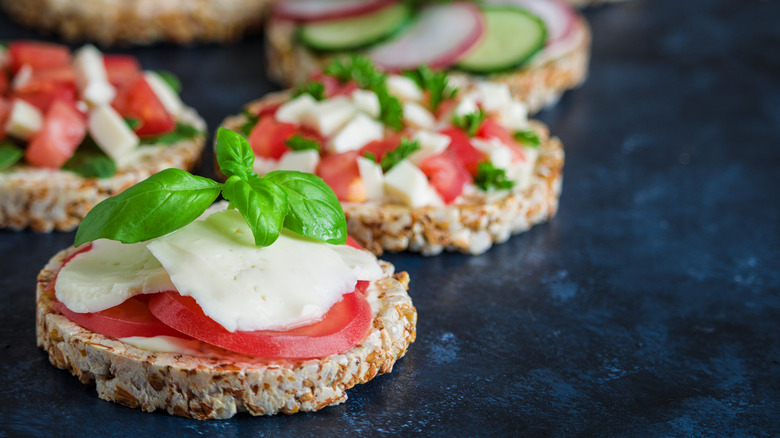 rice cakes topped with tomato and cheese