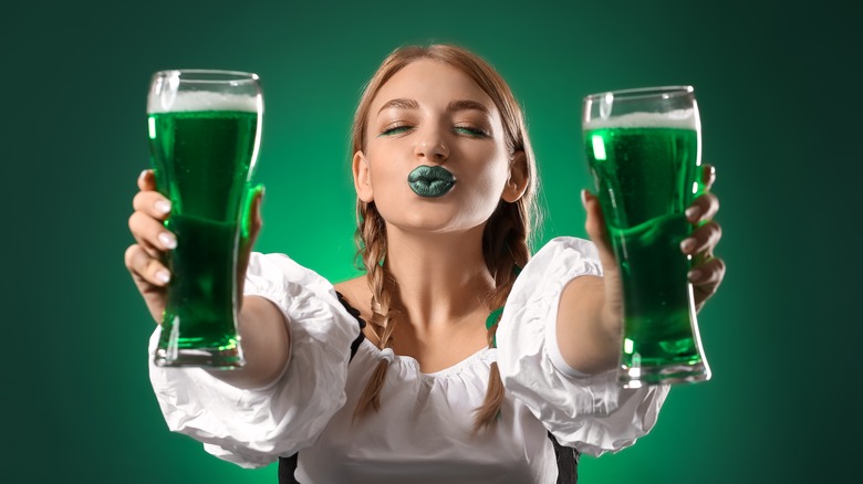 Bartender serves two green beers