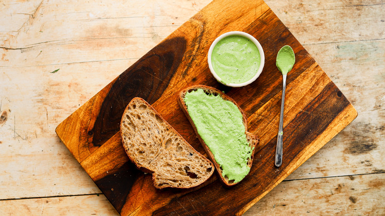 Green dressing spread on bread