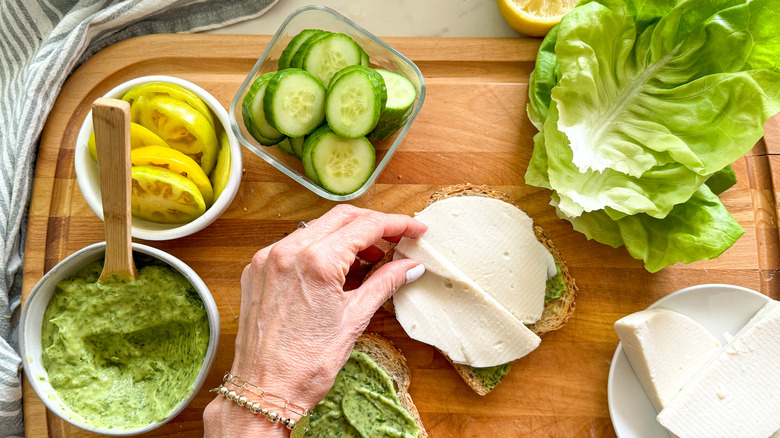 hand making vegetable sandwich