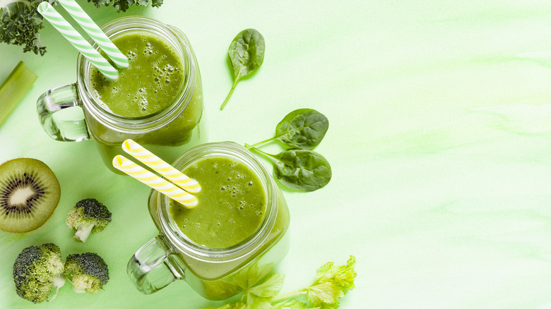 Two green smoothies with straws