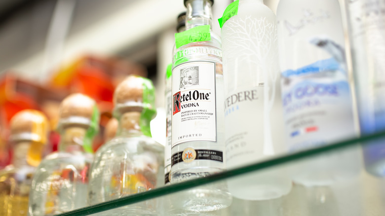 a Ketel One bottle in focus on a shelf of liquor bottles