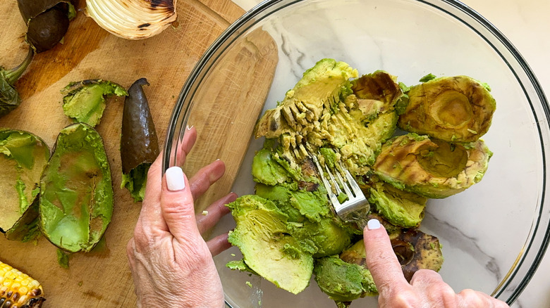 fork mashing avocado