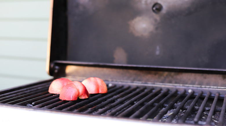 Halved nectarines on hot grill