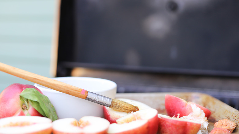 Brushing nectarines with honey syrup