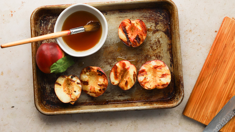 Grilled nectarine halves on tray