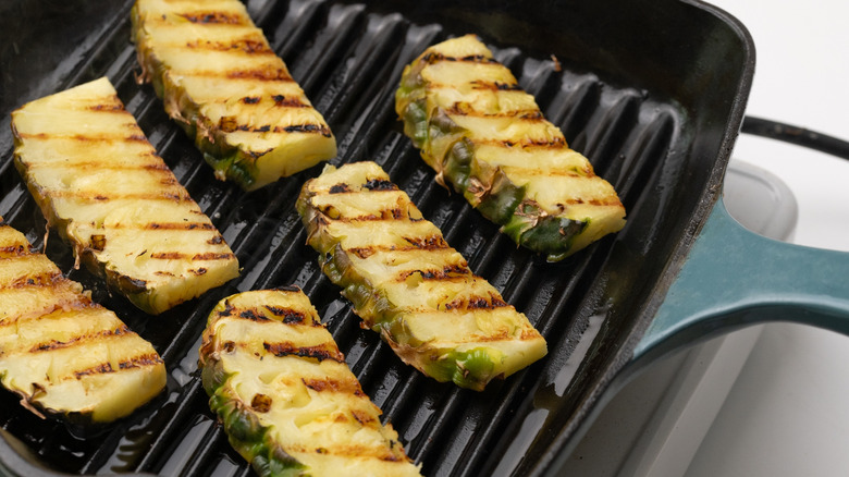 charred pineapple slices on grill pan