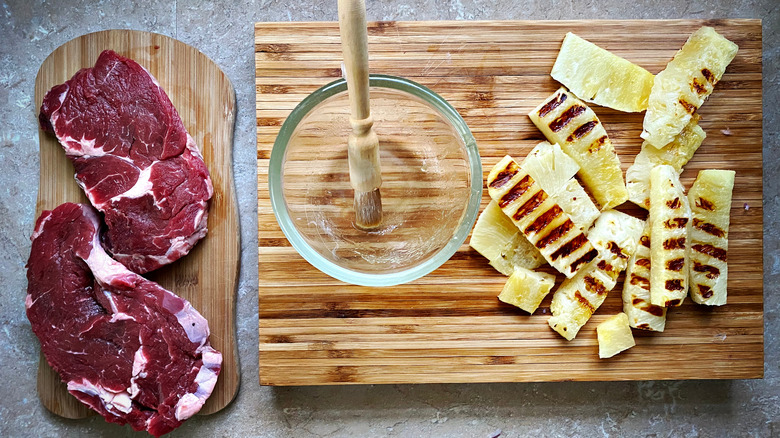 Steak with grilled pineapple on boards