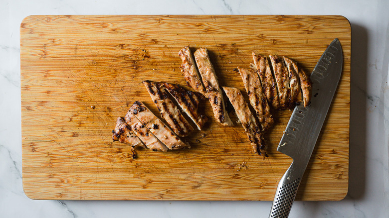 sliced chicken on board