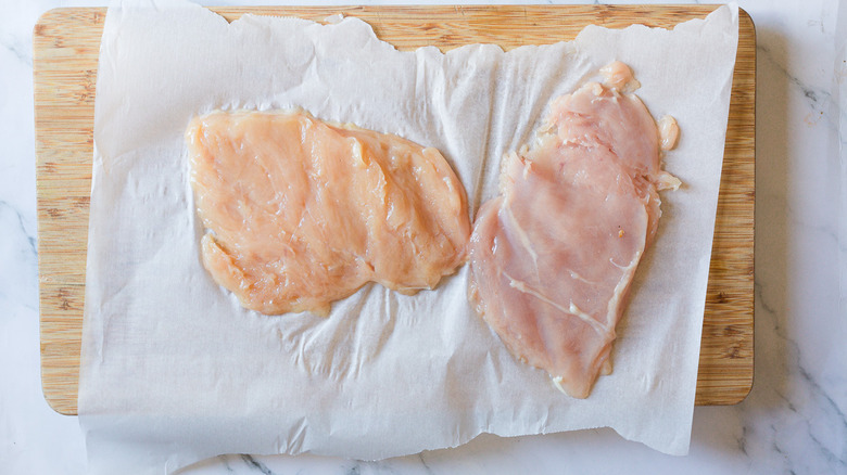 Flattened chicken on cutting board