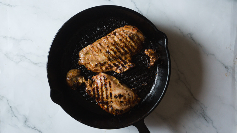 Grilled chicken breasts in cast iron pan