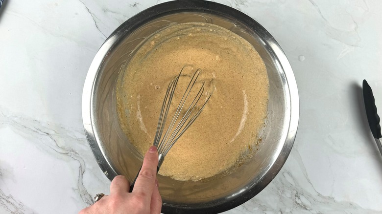 whisking tandoori marinade in bowl