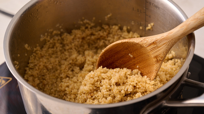 stirring quinoa in a pot