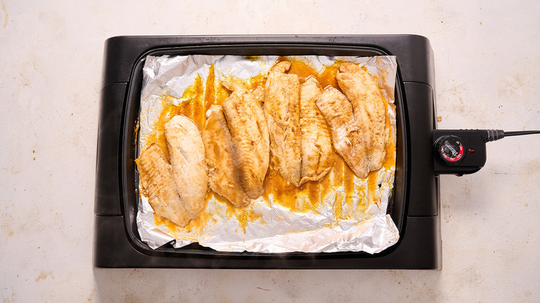 grilling tilapia on grill
