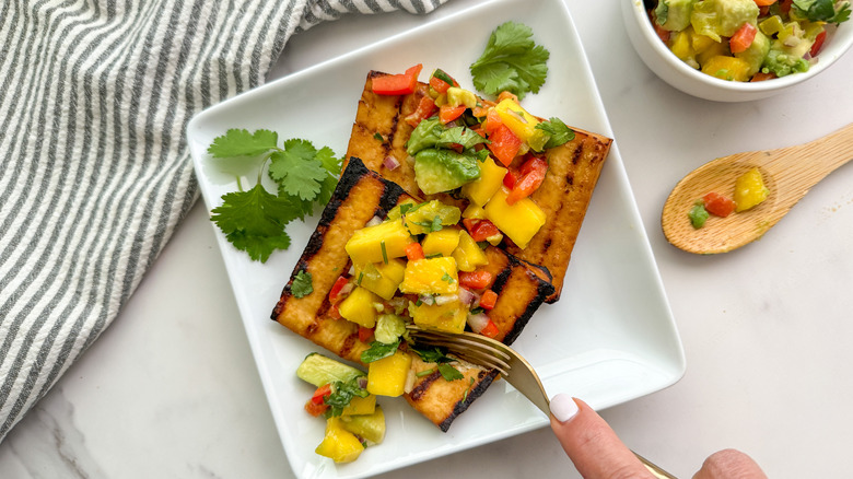 fork cutting into tofu