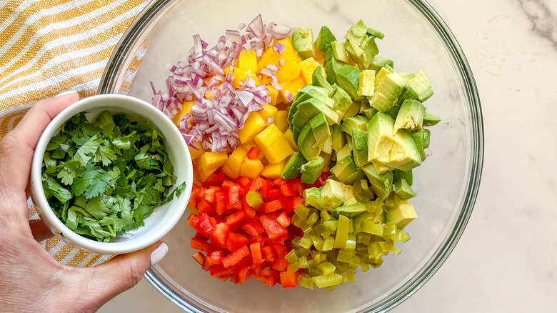 adding cilantro to bowl