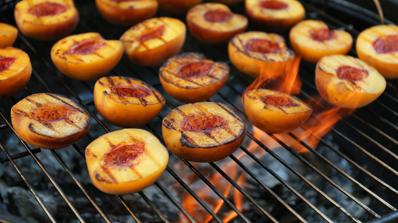 halved peaches on grill