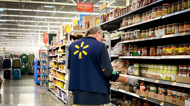 Walmart grocery employee checking prices