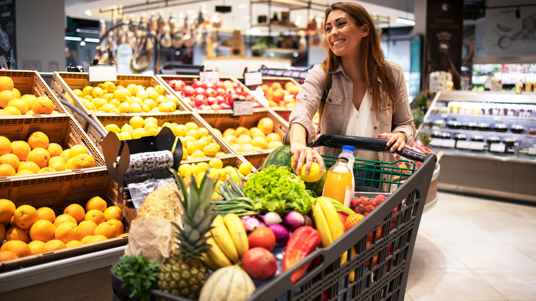 A shopper with a full grocery cart