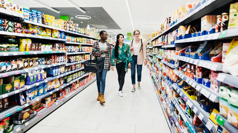 Three girls browsing a supermarket