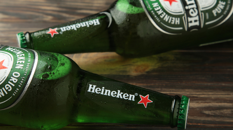 Two bottles of Heineken beer on a wooden table