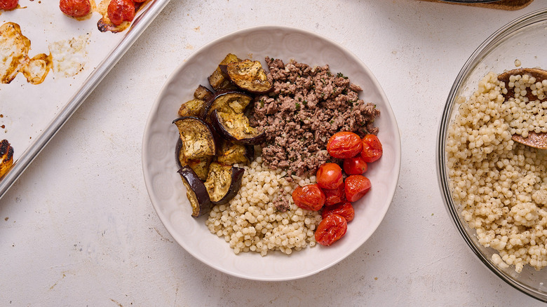 lamb, vegetables, and couscous in bowl