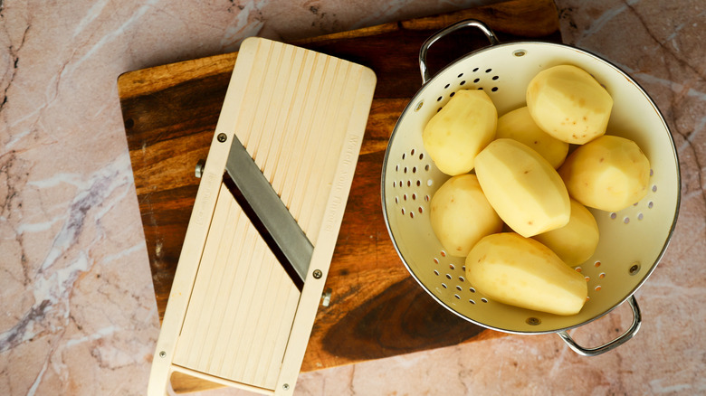 Peeled potatoes with mandoline