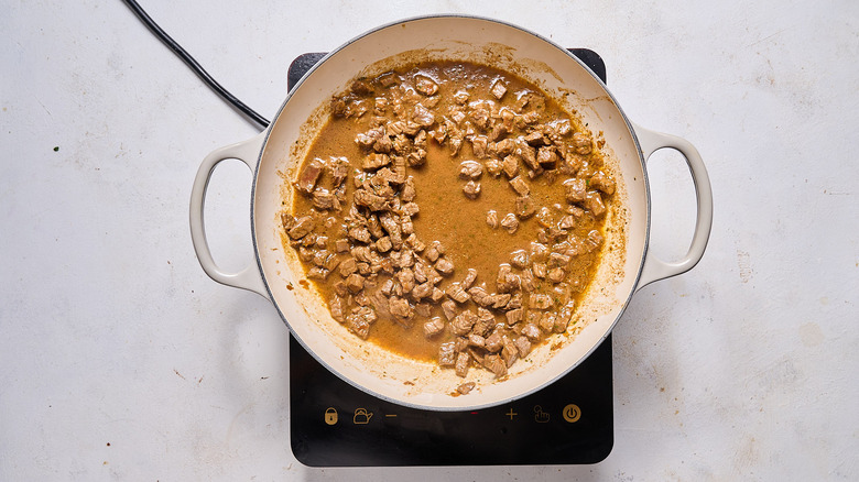 cooking steak in skillet