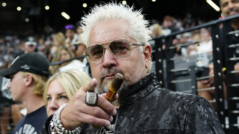 Guy Fieri holding a cigar