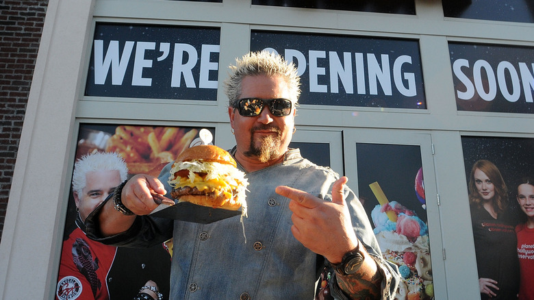 Guy Fieri holding a burger