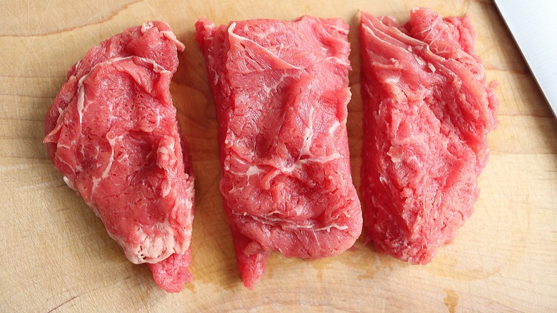 three clumps of shaved beef