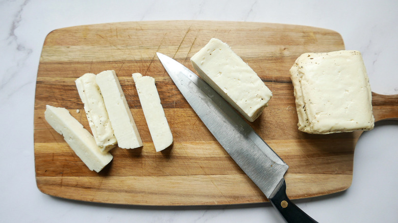 sliced halloumi cheese with knife