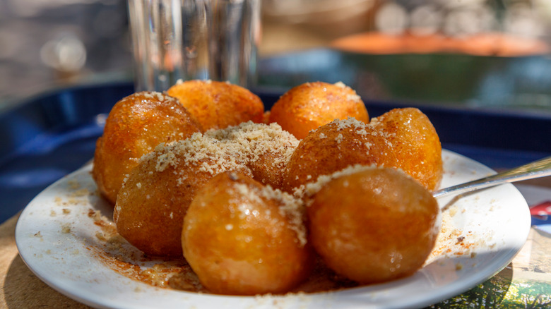 golden loukoumades covered in cinnamon