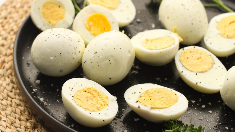 peeled boiled eggs with salt and pepper