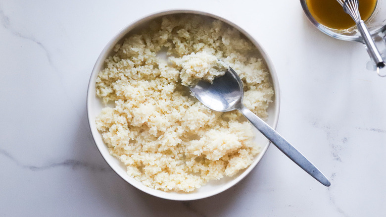 couscous and spoon in bowl