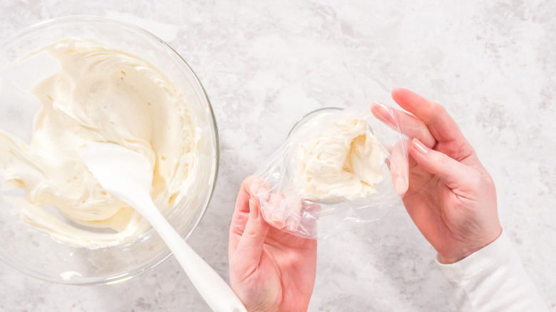 filling piping bag with buttercream