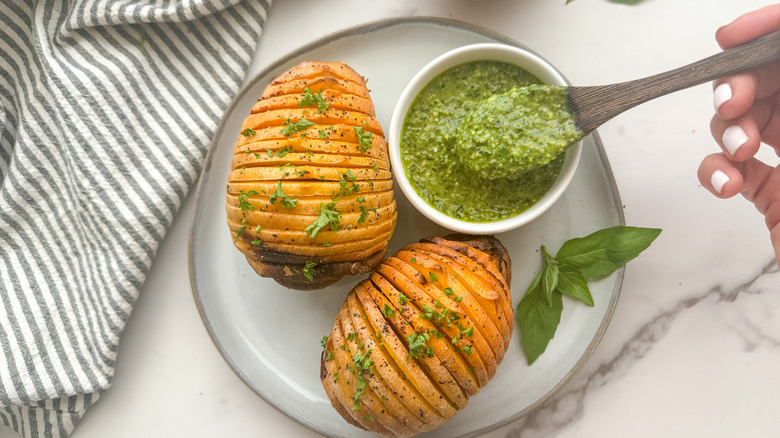 hand with spoon of sauce