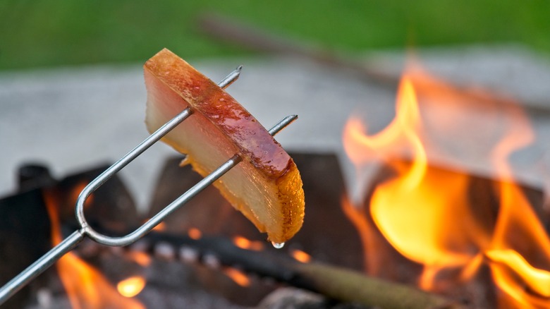 bread slice cooking on skewer