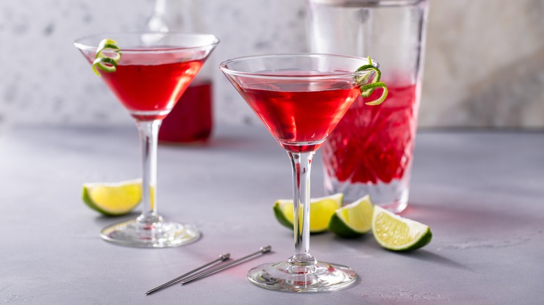 Two cosmopolitan cocktails with limes