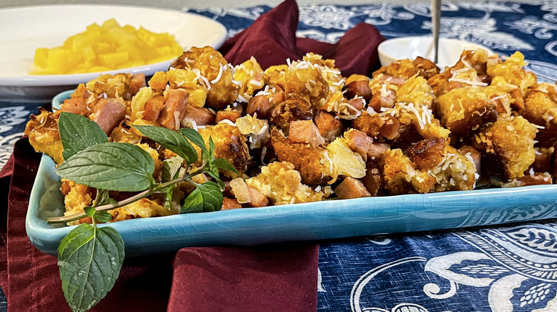 hawaiian stuffing with herb garnish on serving tray