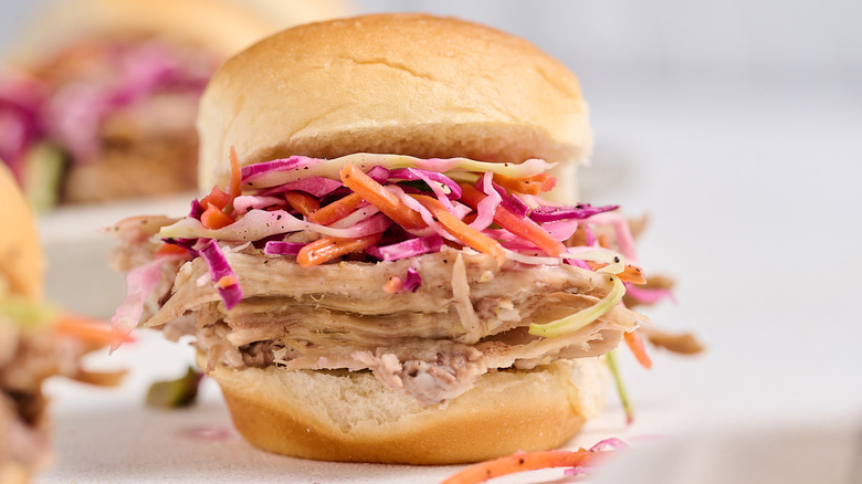 pulled pork sandwich with coleslaw on table