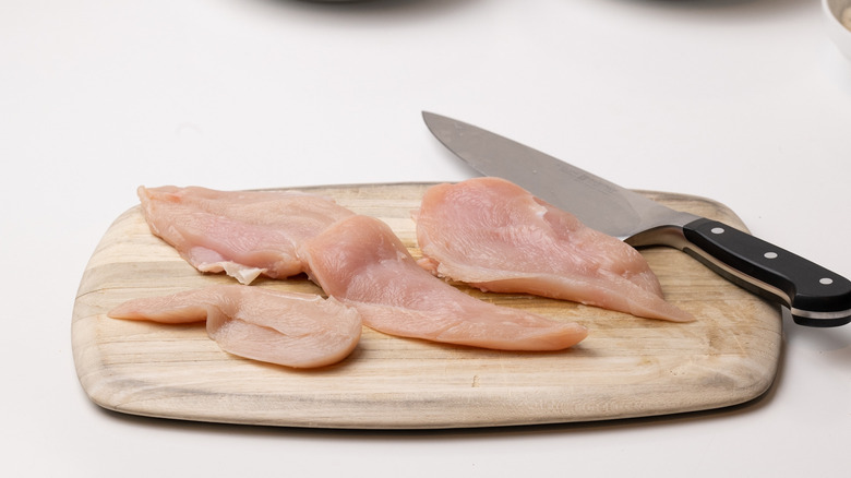 sliced chicken on chopping board