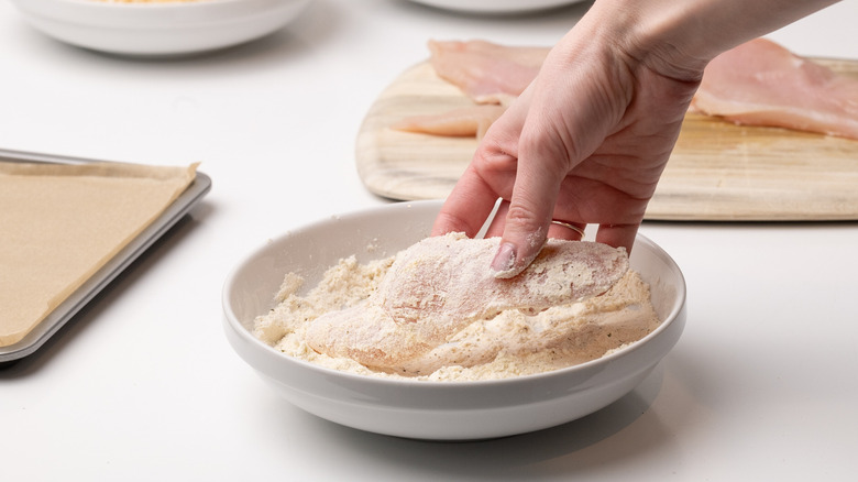 coating chicken cutlet in flour