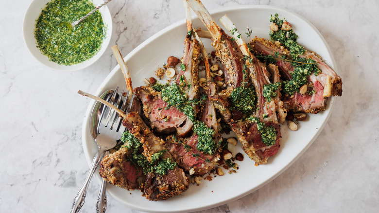 Lamb chops with mint pesto on white platter