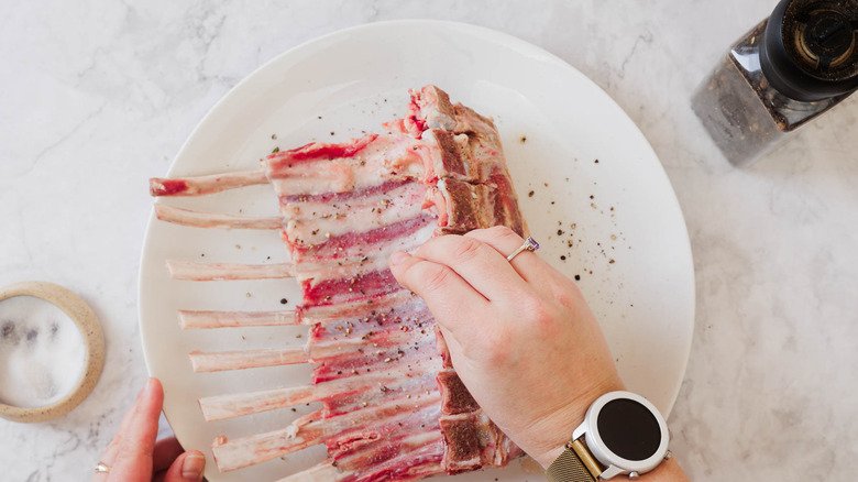 Seasoning chops with salt and pepper