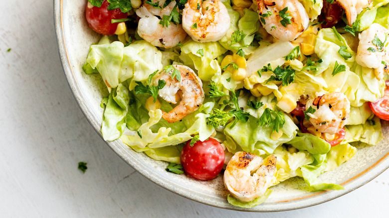 Grilled shrimp salad on white plate