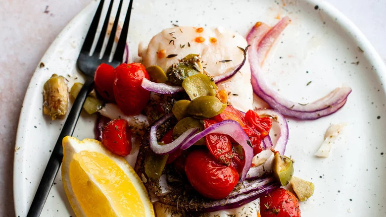Cod with onions, tomatoes, lemon