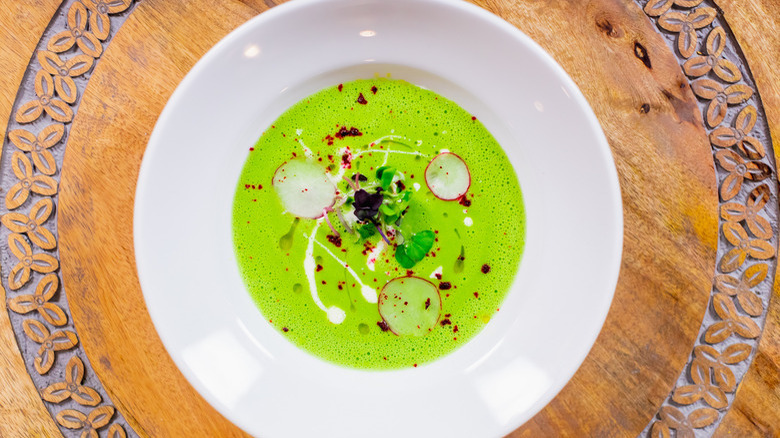 Watercress soup on wooden board