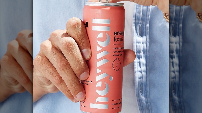 hand holding Heywell energy drink