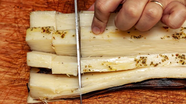 cutting slices of marinated hearts of palm